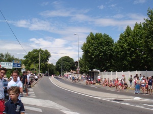 A section of the street with the crowd waiting for the Tour de France cyclists